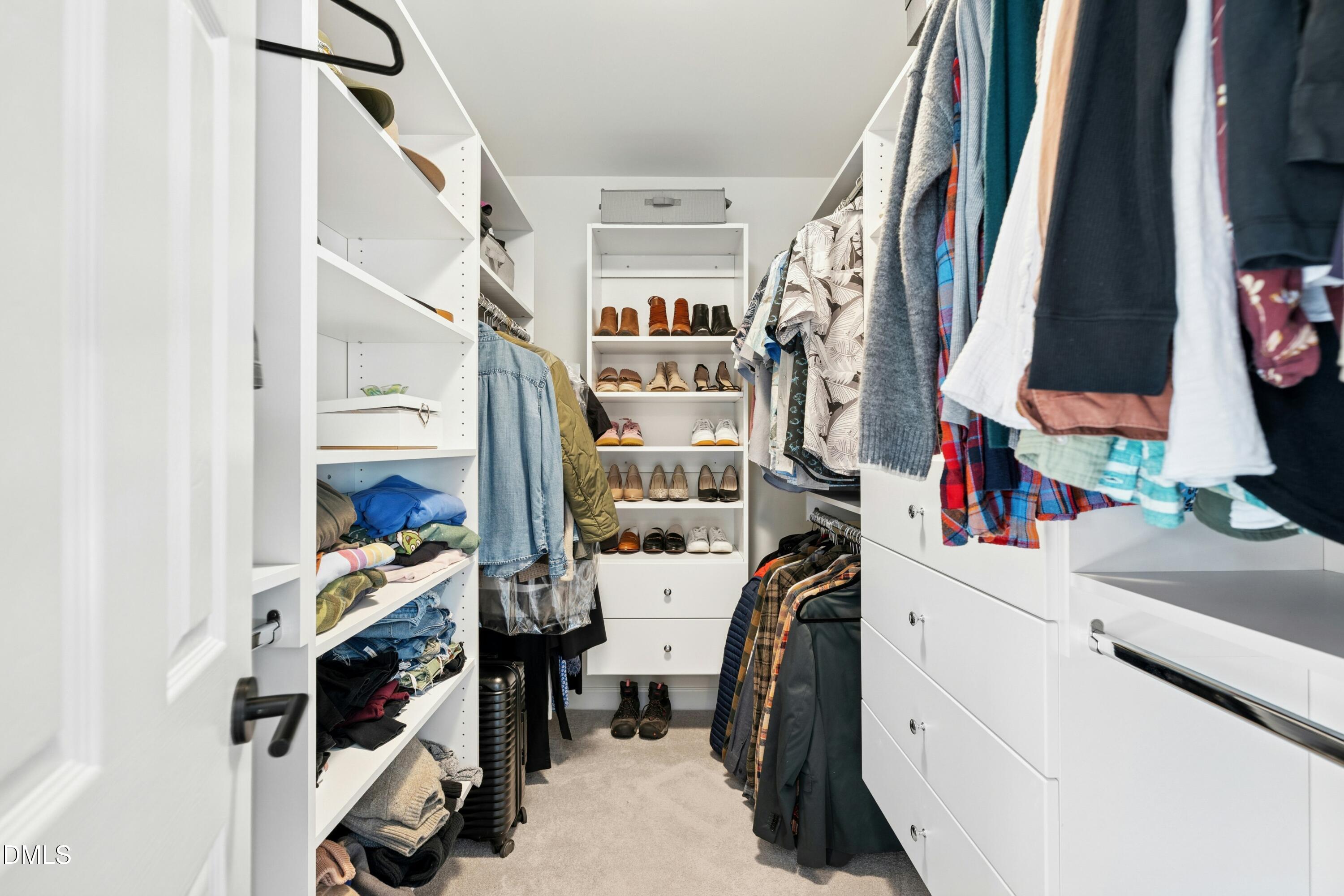 117 Barnes Spring Court Cary, NC 27519 - Photo 23 of 38 a view of walk in closet with clothes and shoes