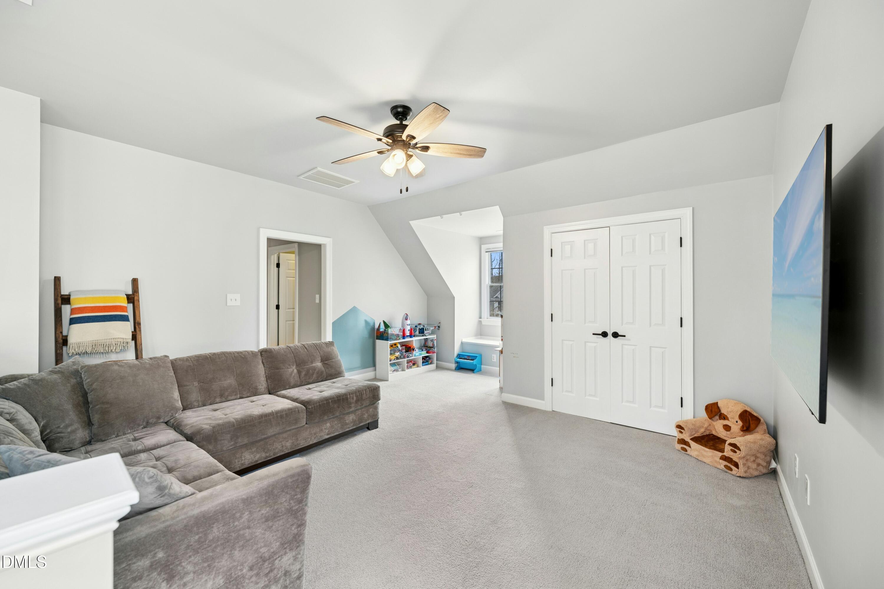 117 Barnes Spring Court Cary, NC 27519 - Photo 24 of 38 a living room with furniture and a flat screen tv