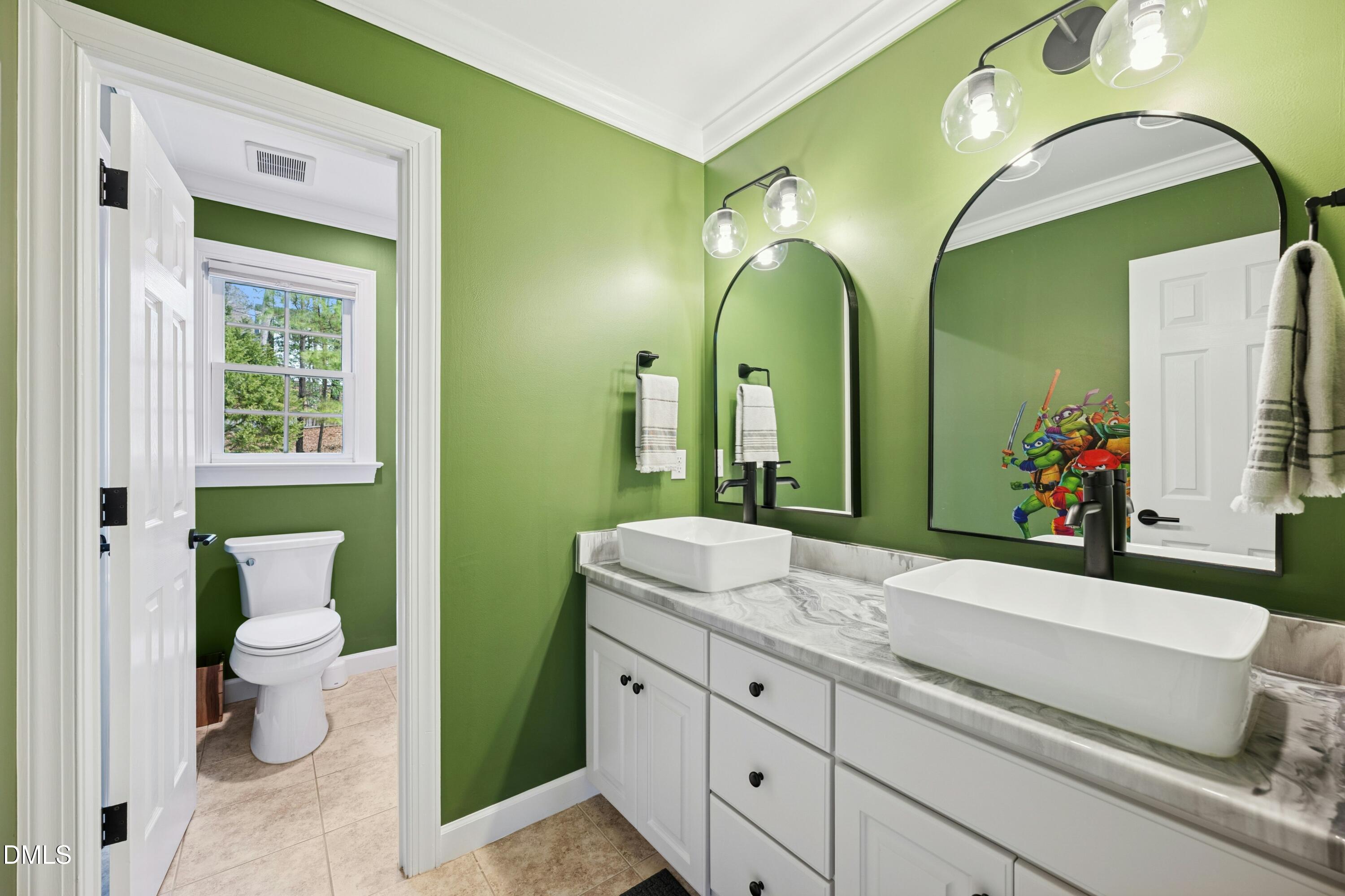 117 Barnes Spring Court Cary, NC 27519 - Photo 26 of 38 a bathroom with a double vanity sink and a mirror