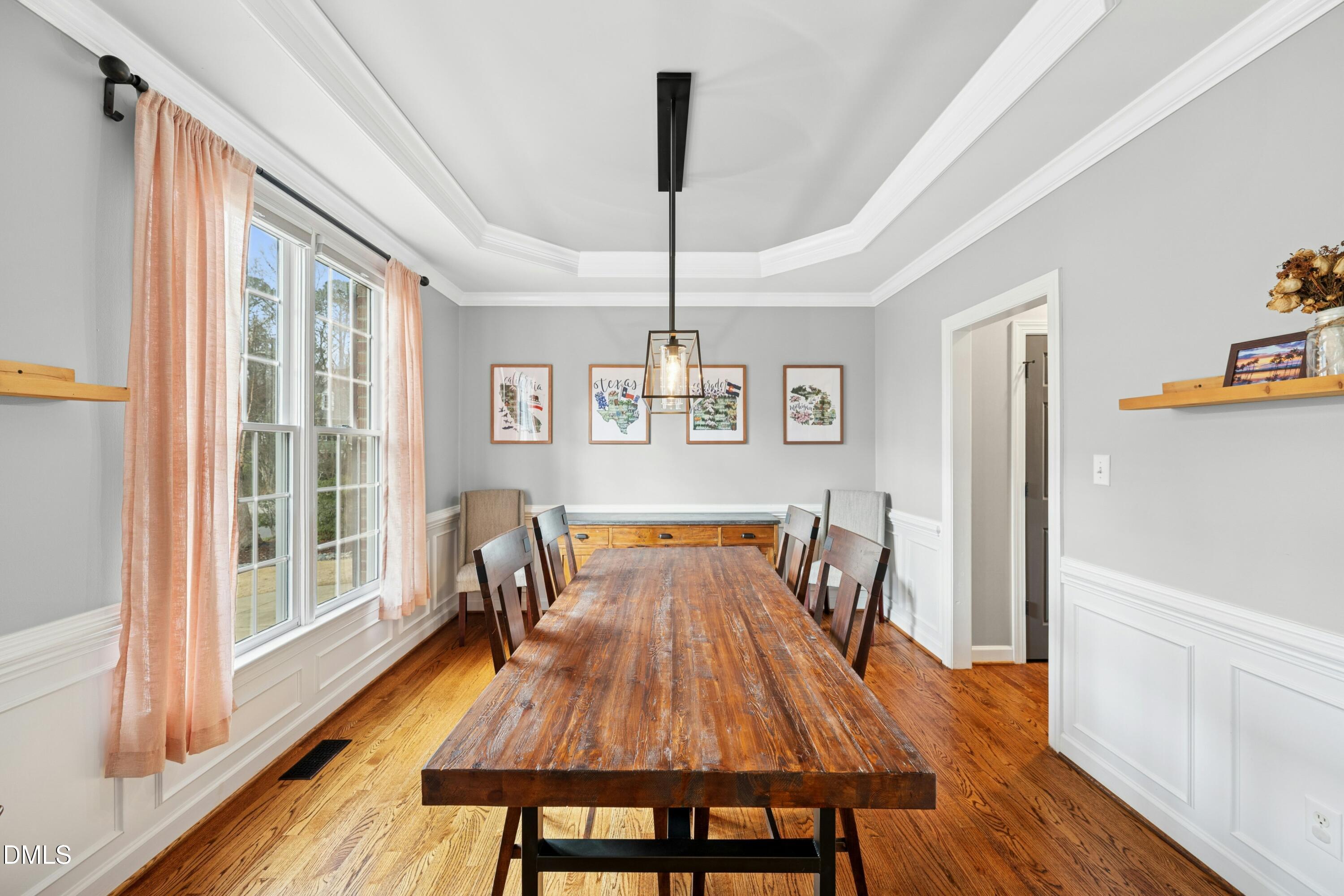 117 Barnes Spring Court Cary, NC 27519 - Photo 4 of 38 a dining room with furniture a chandelier and wooden floor