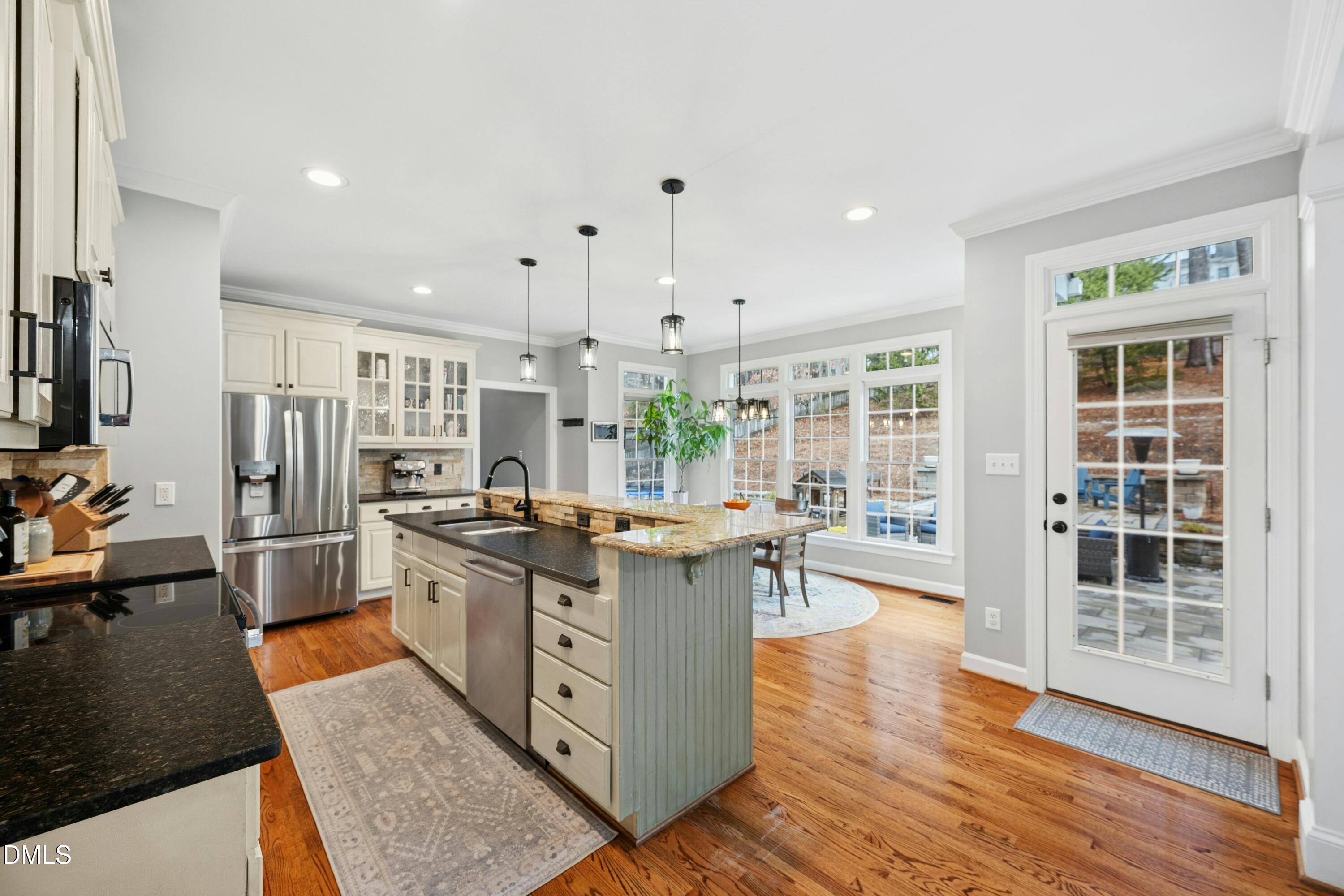 117 Barnes Spring Court Cary, NC 27519 - Photo 10 of 38 a kitchen with stainless steel appliances granite countertop a stove oven and a refrigerator