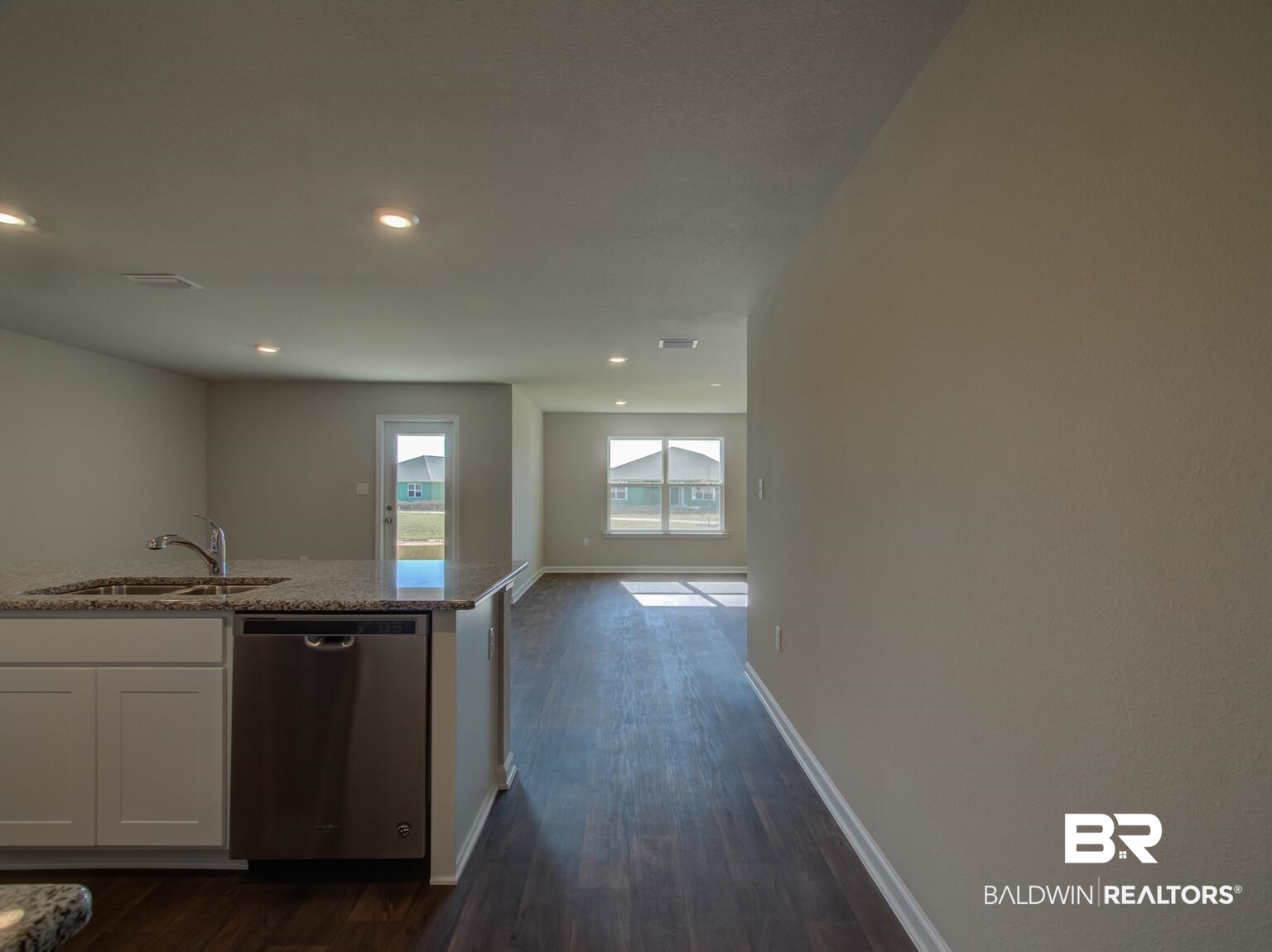 23953 Citation Loop Daphne, AL 36526 - Photo 6 of 49 Kitchen with dishwasher, white cabinets, dark wood-style flooring, light stone counters, and recessed lighting