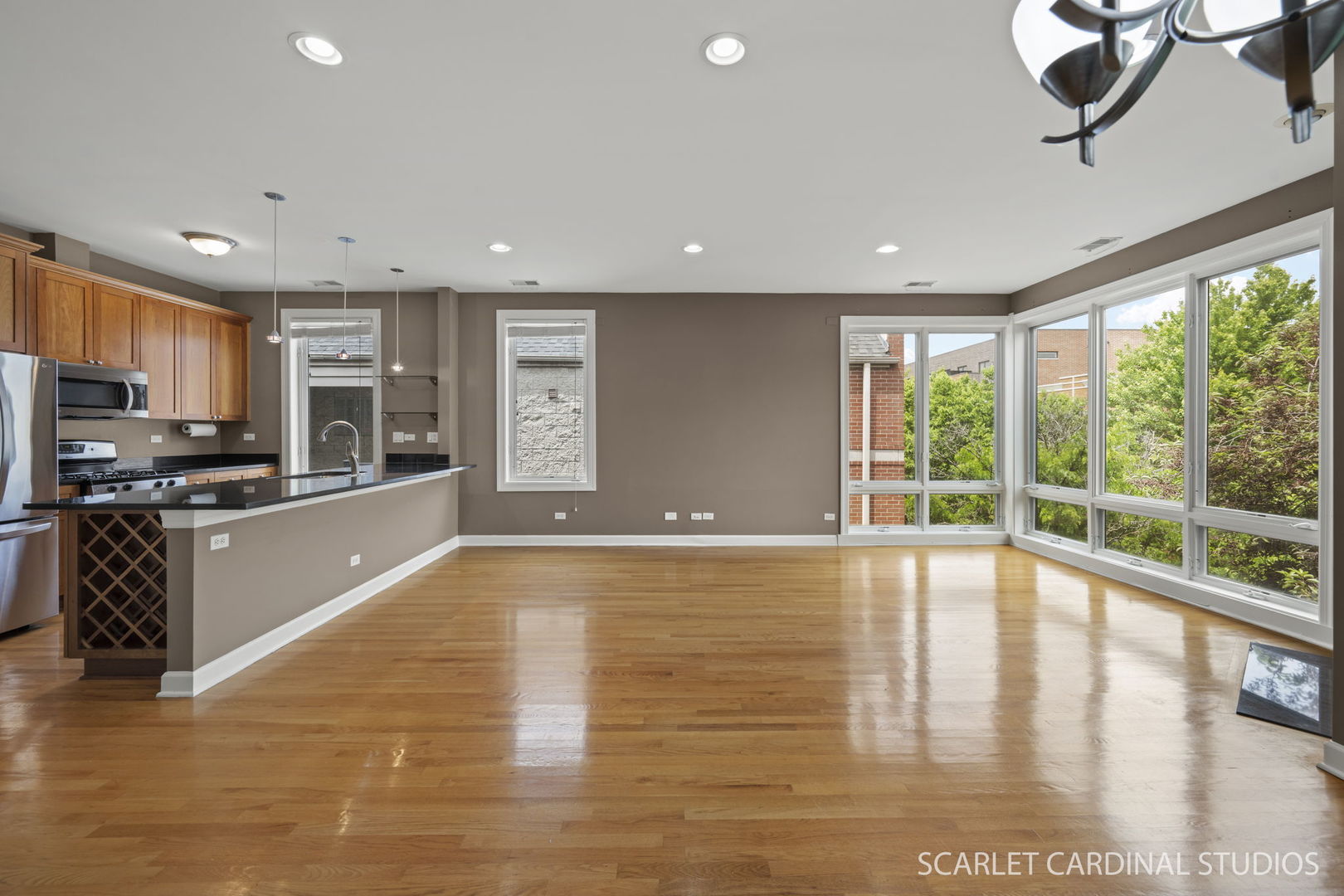 1419 West Fillmore Street, Unit 3W Chicago, IL 60607 - Photo 7 of 26 a large kitchen with stainless steel appliances granite countertop a large counter top a stove and a wooden floors