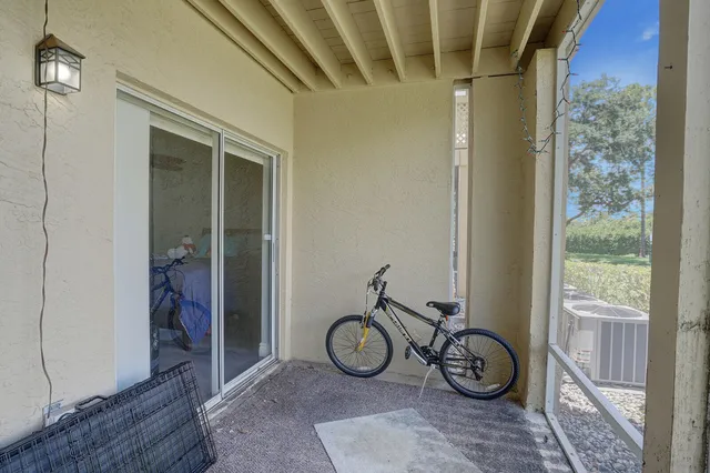 a view of a porch with chairs and a yard