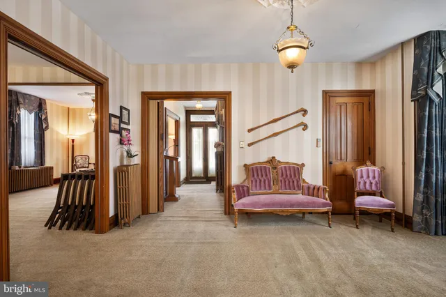 a living room with furniture and a chandelier