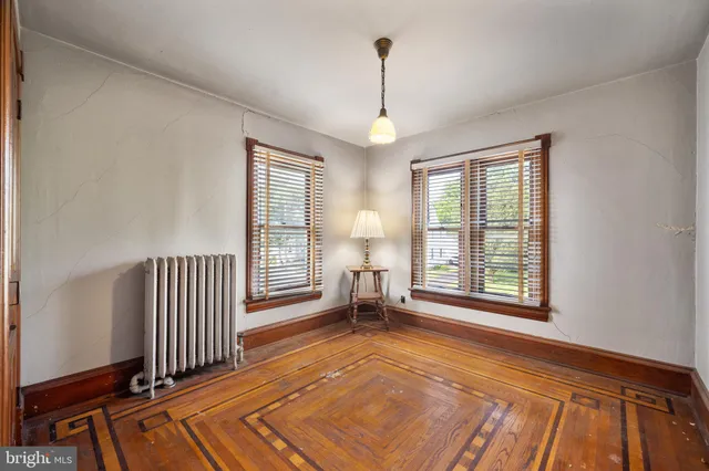 a living room with furniture a window and a chandelier