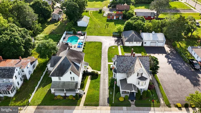an aerial view of a house with a garden and swimming pool