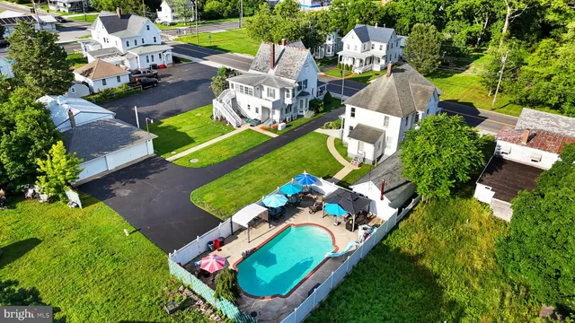 an aerial view of a house with a swimming pool patio and outdoor seating