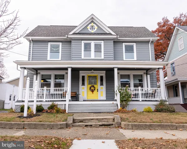 a view of a brick house with lots of windows and plants