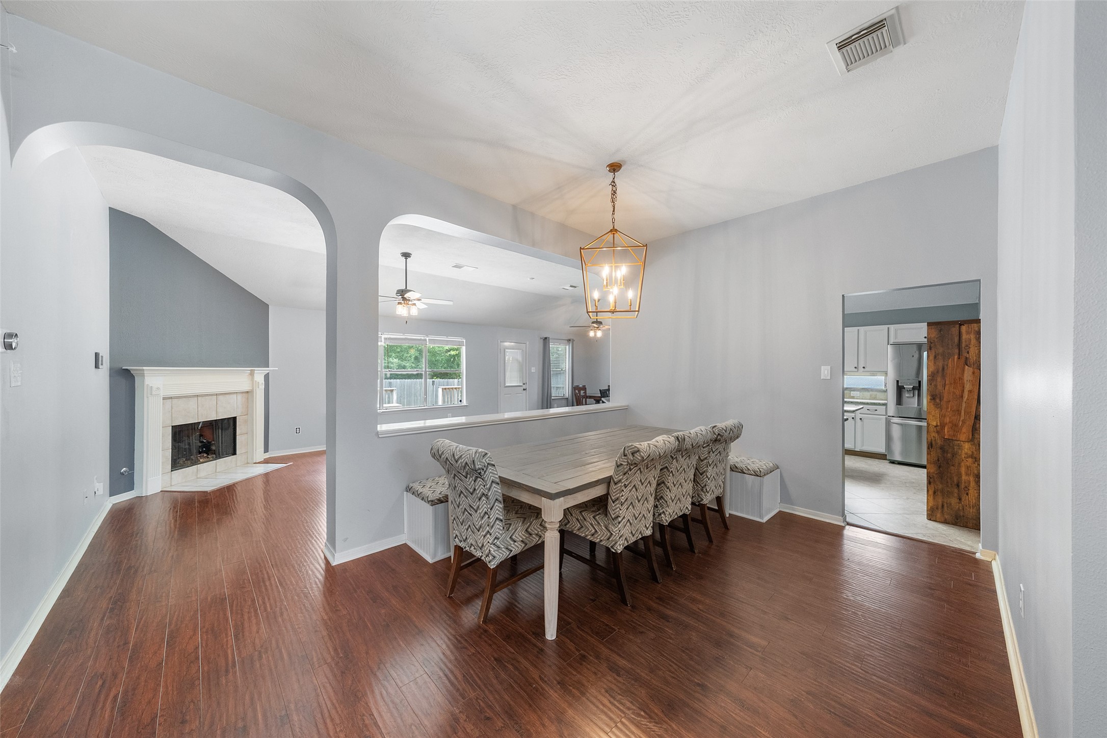 19718 Teller Boulevard Spring, TX 77388 - Photo 5 of 47 a dining room with wooden floor a chandelier a wooden table and chairs