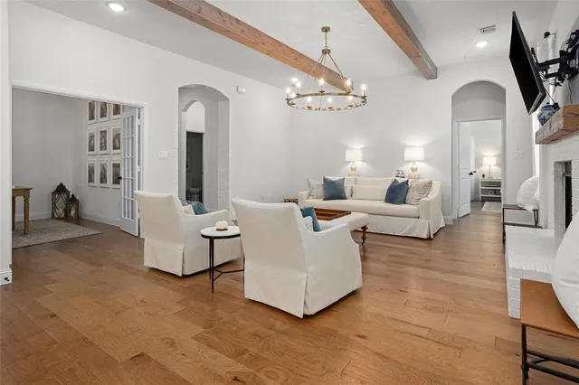 a living room with fireplace furniture and a chandelier