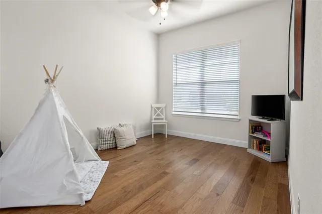 a view of a livingroom with wooden floor and a window