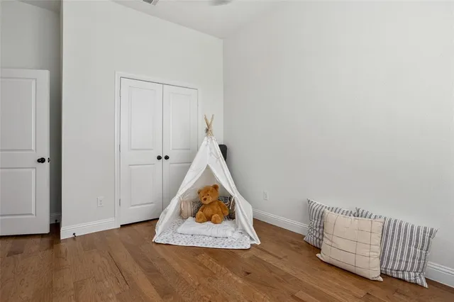 an view of dining room with wooden floor and cabinet