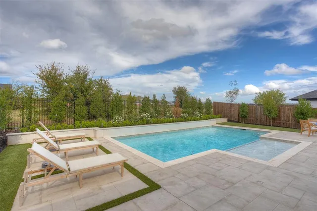 a view of a yard with swimming pool and outdoor seating
