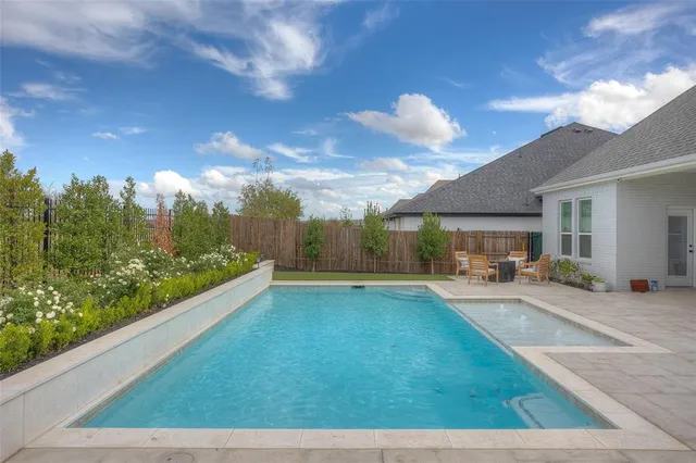 a view of a house with backyard porch and sitting area