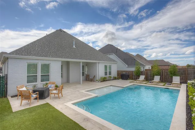 a backyard of a house with table and chairs