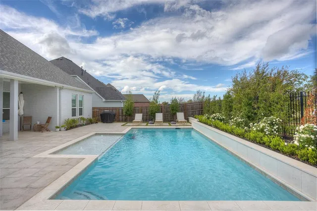a view of a patio with swimming pool table and chairs