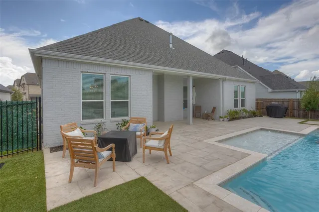 a backyard of a house with table and chairs