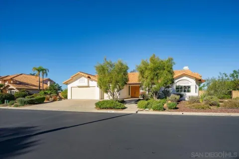 a front view of a house with a yard and a garage