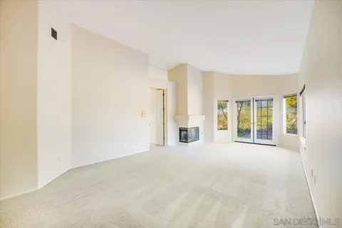 a view of empty room with a fireplace