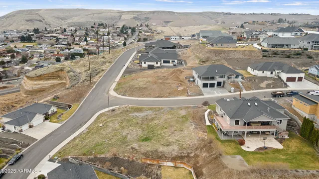 an aerial view of a house with a mountain