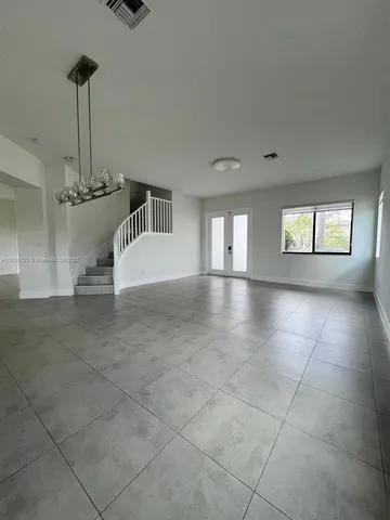 a view of a kitchen with a sink and a window