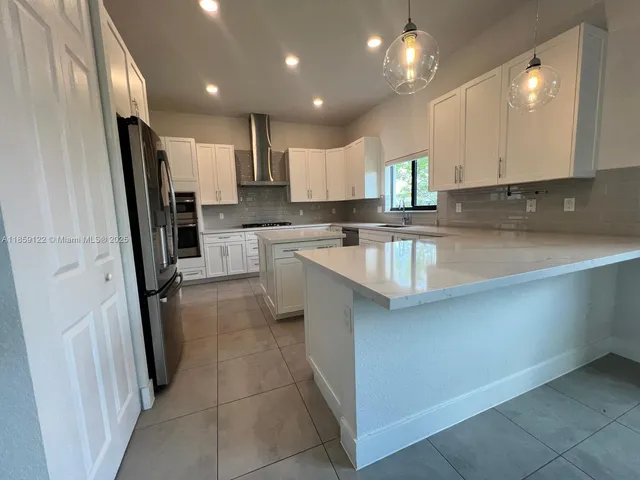 a kitchen with white cabinets and white appliances