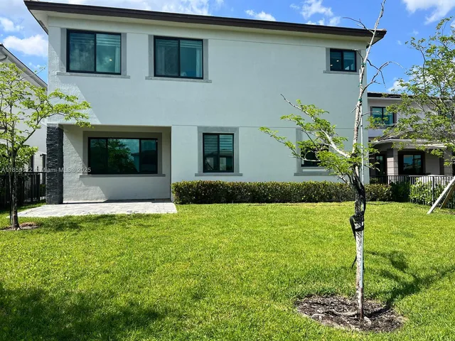 a view of a garden with a house