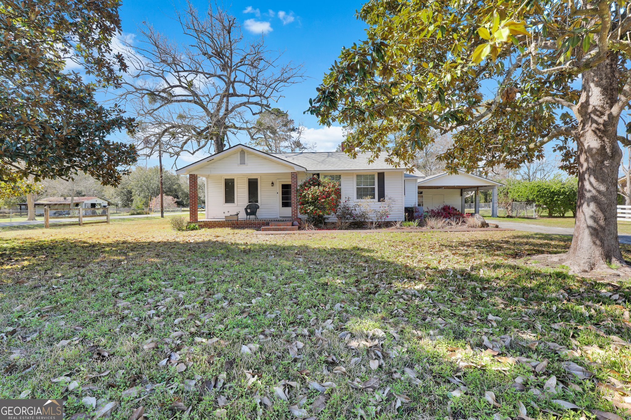 177 Spruce Street Richmond Hill, GA 31324 - Photo 2 of 15 a front view of a house with garden