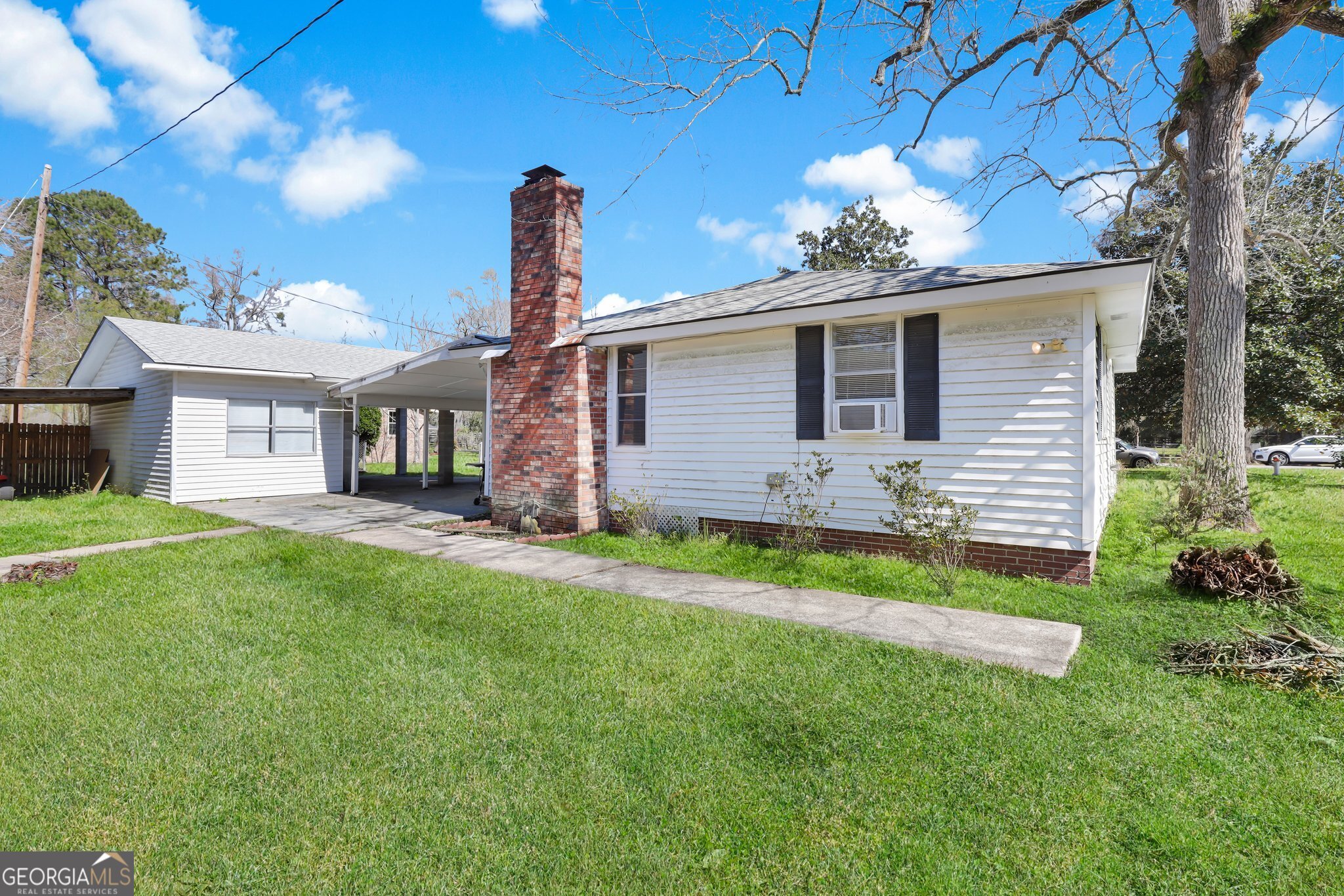 177 Spruce Street Richmond Hill, GA 31324 - Photo 3 of 15 a front view of a house with a garden and yard