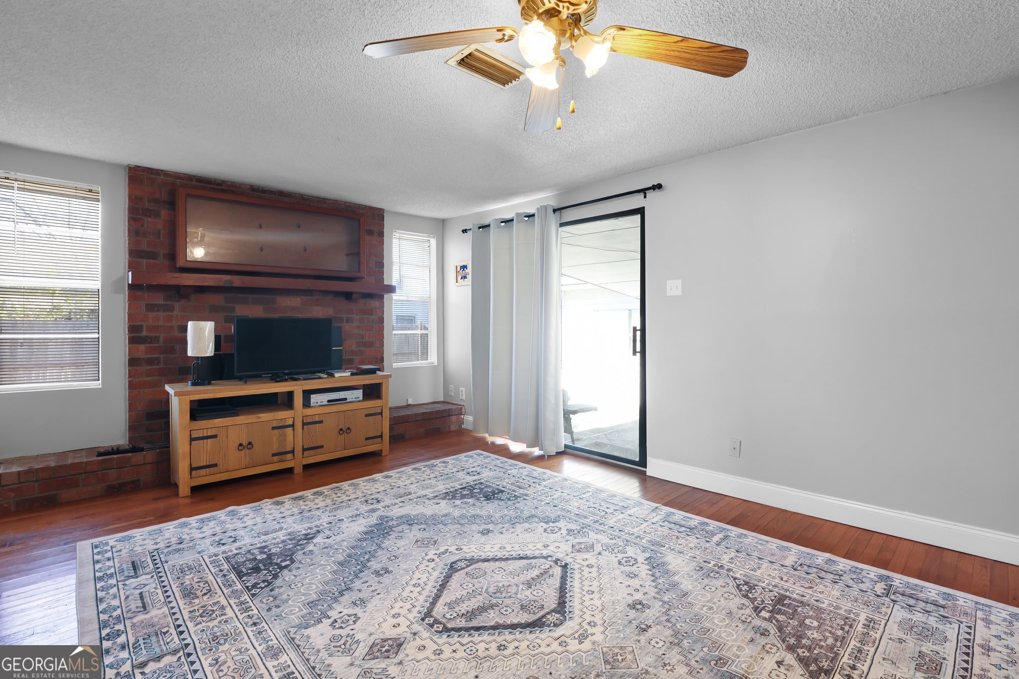 177 Spruce Street Richmond Hill, GA 31324 - Photo 9 of 15 a living room with furniture and a flat screen tv