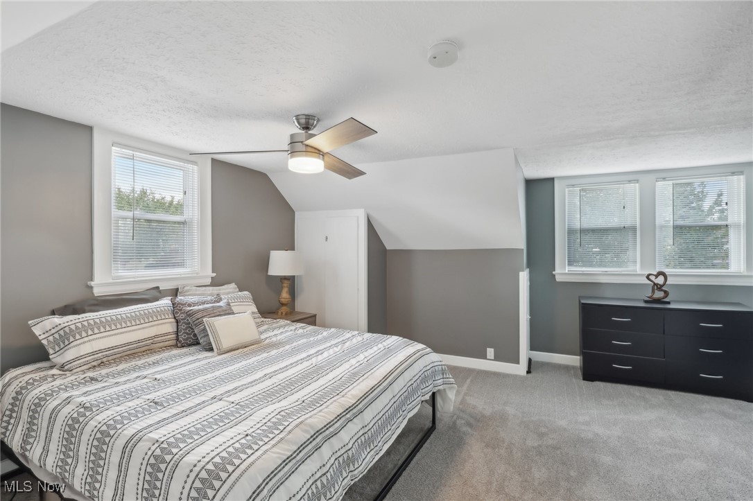 1567 Roselawn Road Cleveland, OH 44124 - Photo 18 of 29 Bedroom featuring a textured ceiling, vaulted ceiling, ceiling fan, and carpet floors