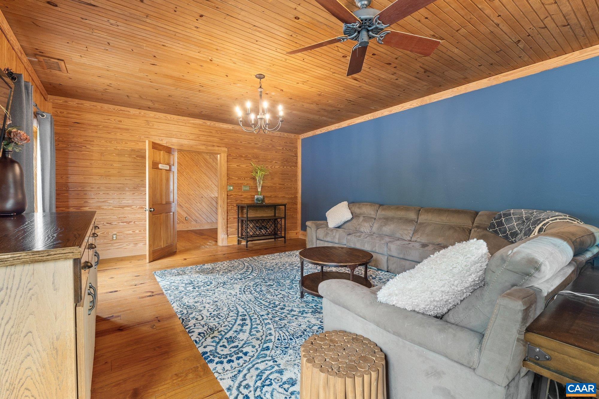 1376 A Wyatt Mountain Road Dyke, VA 22935 - Photo 42 of 58 a living room with furniture and a chandelier