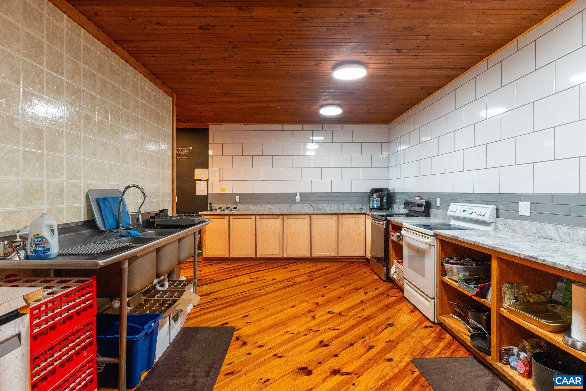 1376 A Wyatt Mountain Road Dyke, VA 22935 - Photo 44 of 58 a kitchen with stainless steel appliances granite countertop a sink and stove