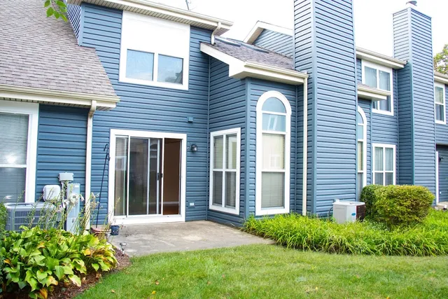 a view of a house with a yard and a garden