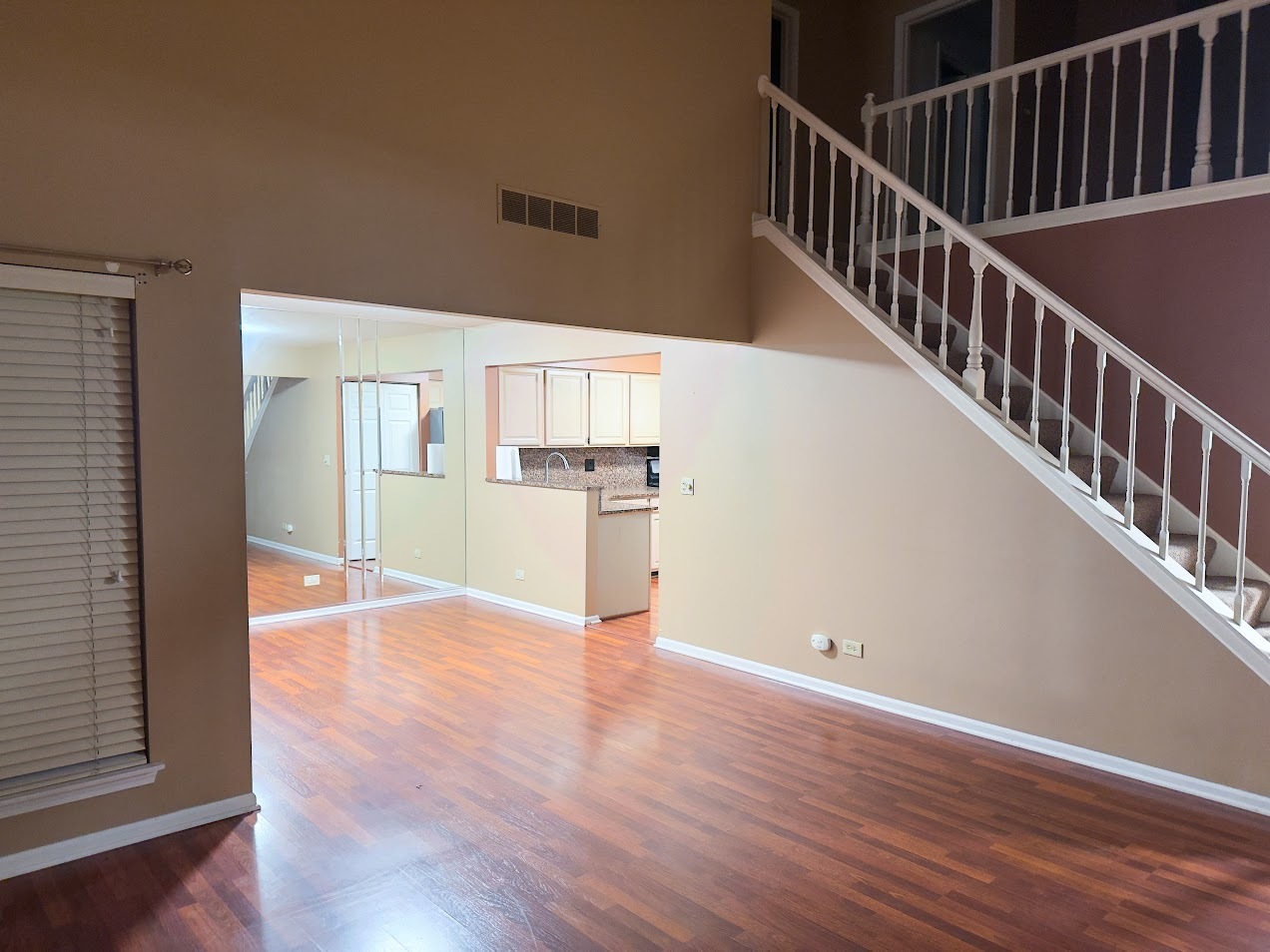 1042 Ridgefield Circle, Unit 1042 Carol Stream, IL 60188 - Photo 5 of 13 a view of a hallway with wooden floor and staircase