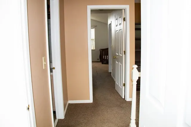 a view of a bathroom from a hallway