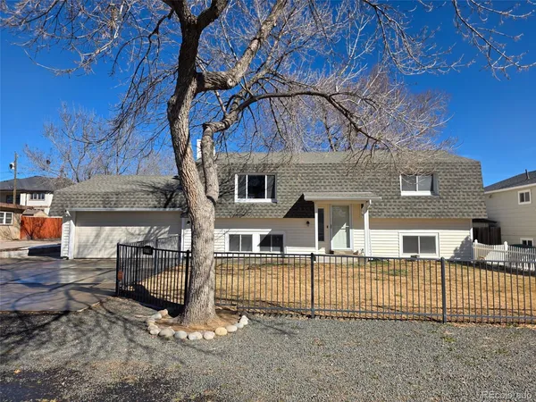 a front view of a house with a iron gate