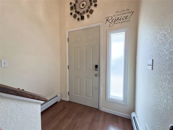 a view of an entryway with wooden floor