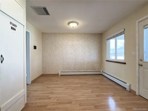 wooden floor in an empty room with a window