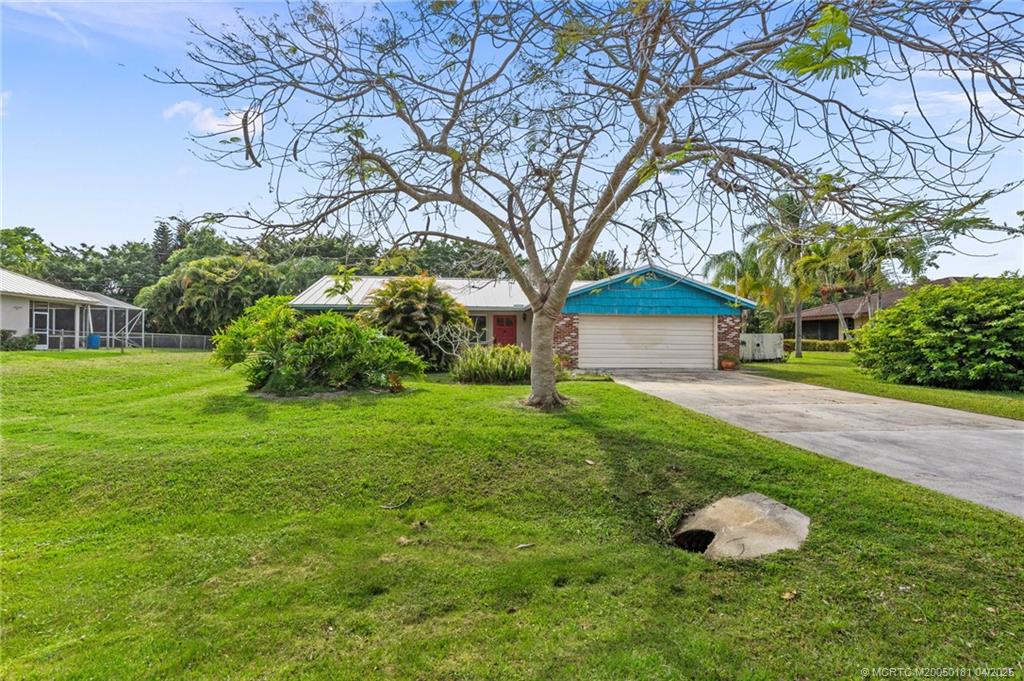 2416 North W Everglades Boulevard Stuart, FL 34994 - Photo 3 of 9 a backyard of a house with lots of green space