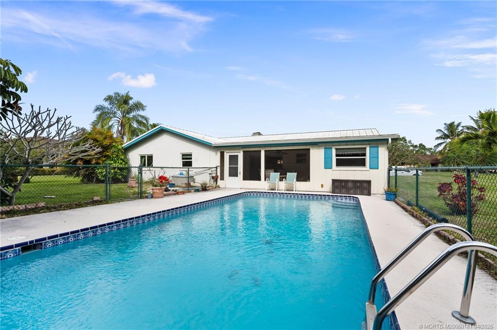 2416 North W Everglades Boulevard Stuart, FL 34994 - Photo 4 of 9 a front view of house with yard and outdoor seating