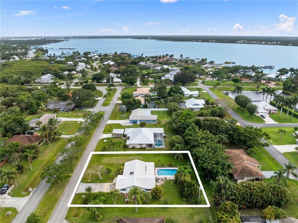 2416 North W Everglades Boulevard Stuart, FL 34994 - Photo 5 of 9 an aerial view of multiple houses with yard