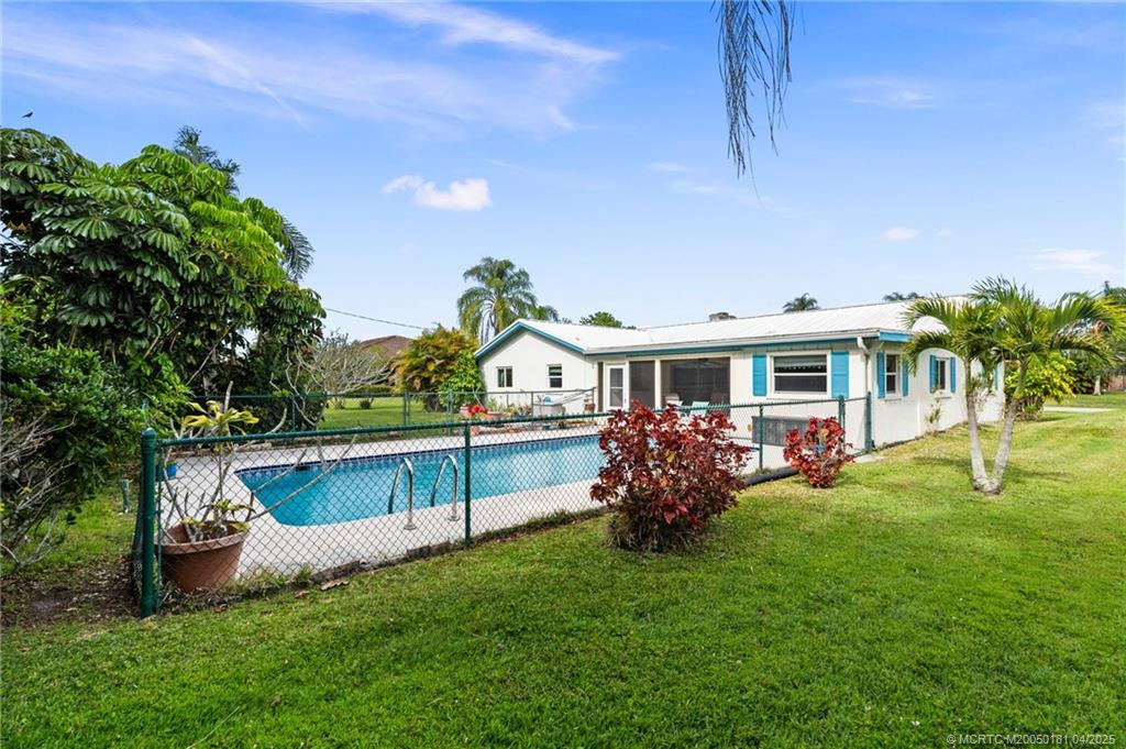 2416 North W Everglades Boulevard Stuart, FL 34994 - Photo 6 of 9 a front view of house with yard and outdoor seating