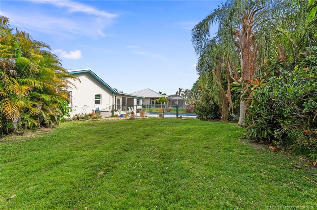 2416 North W Everglades Boulevard Stuart, FL 34994 - Photo 7 of 9 a view of yard with swimming pool and green space