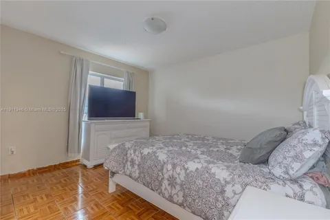 a bedroom with a large bed and a dresser