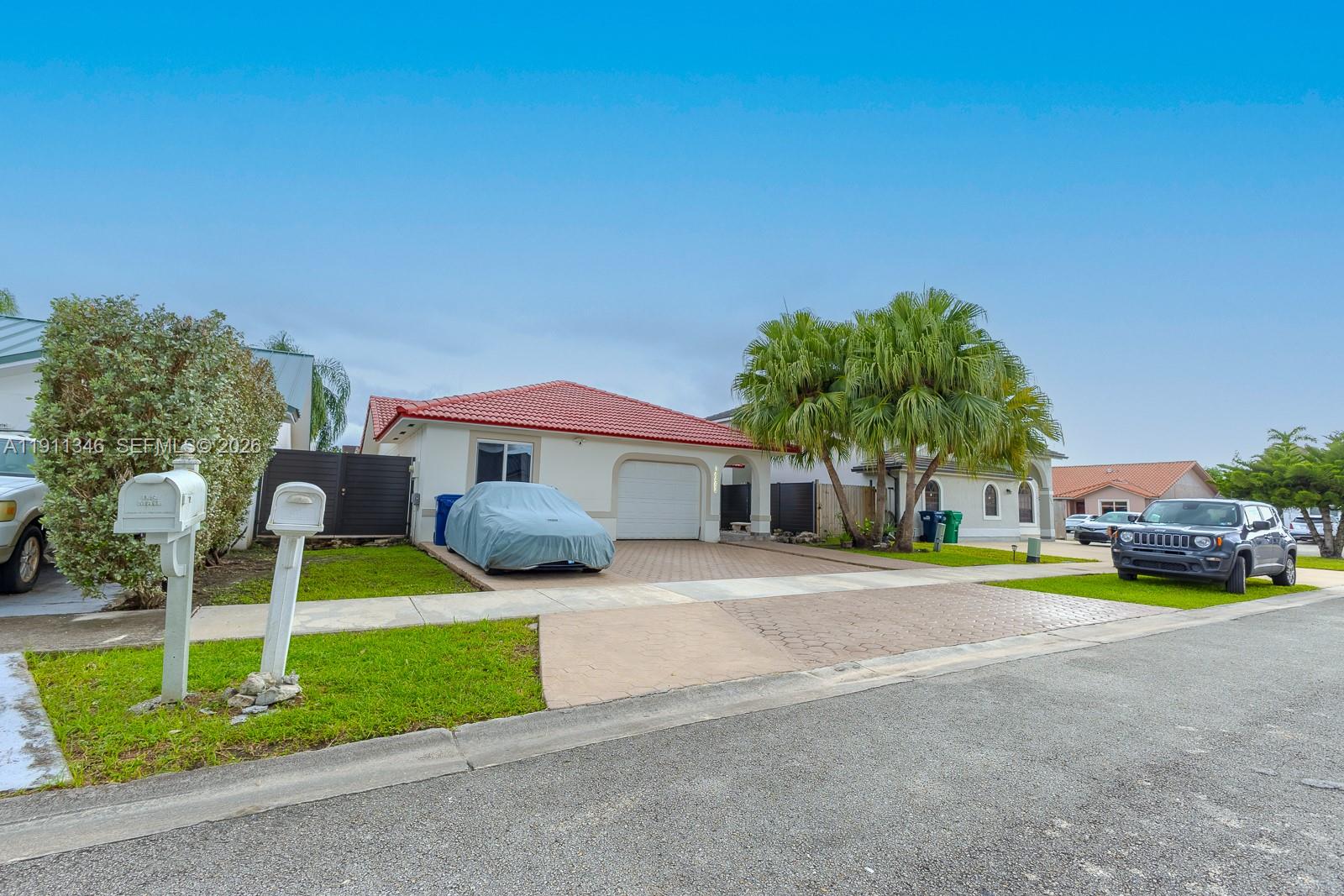 14452 Southwest 115th Street Miami, FL 33186 - Photo 21 of 22 a front view of a house with a yard and porch