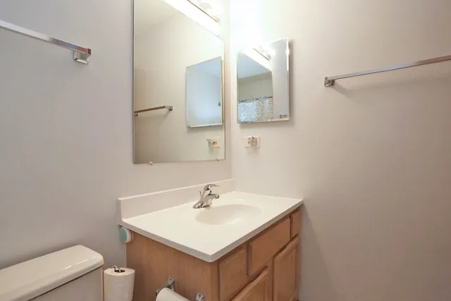 a bathroom with a sink toilet and mirror