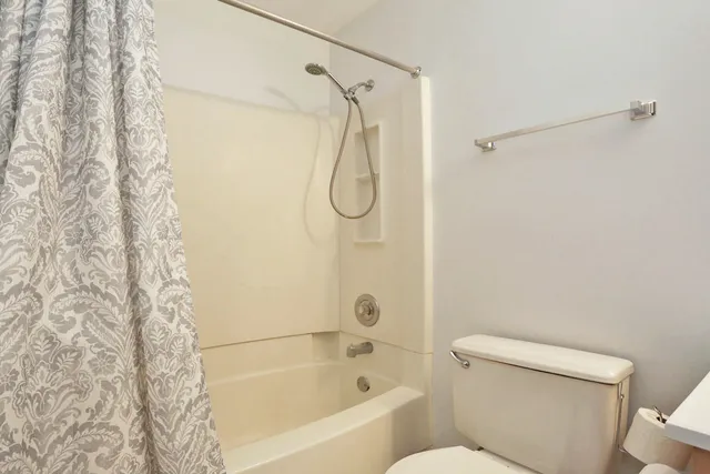 a bathroom with a toilet and shower