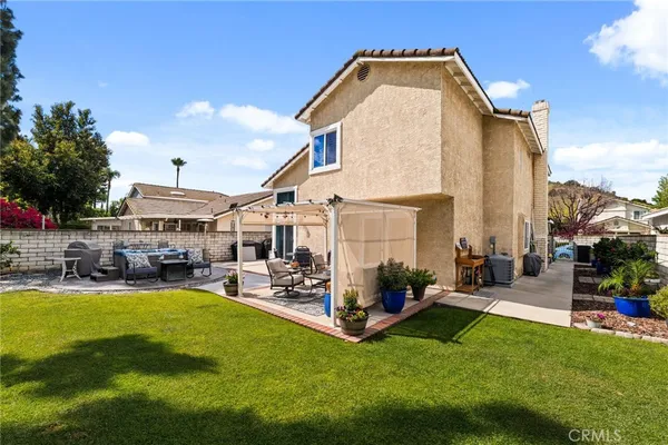 a view of a backyard with sitting area and garden